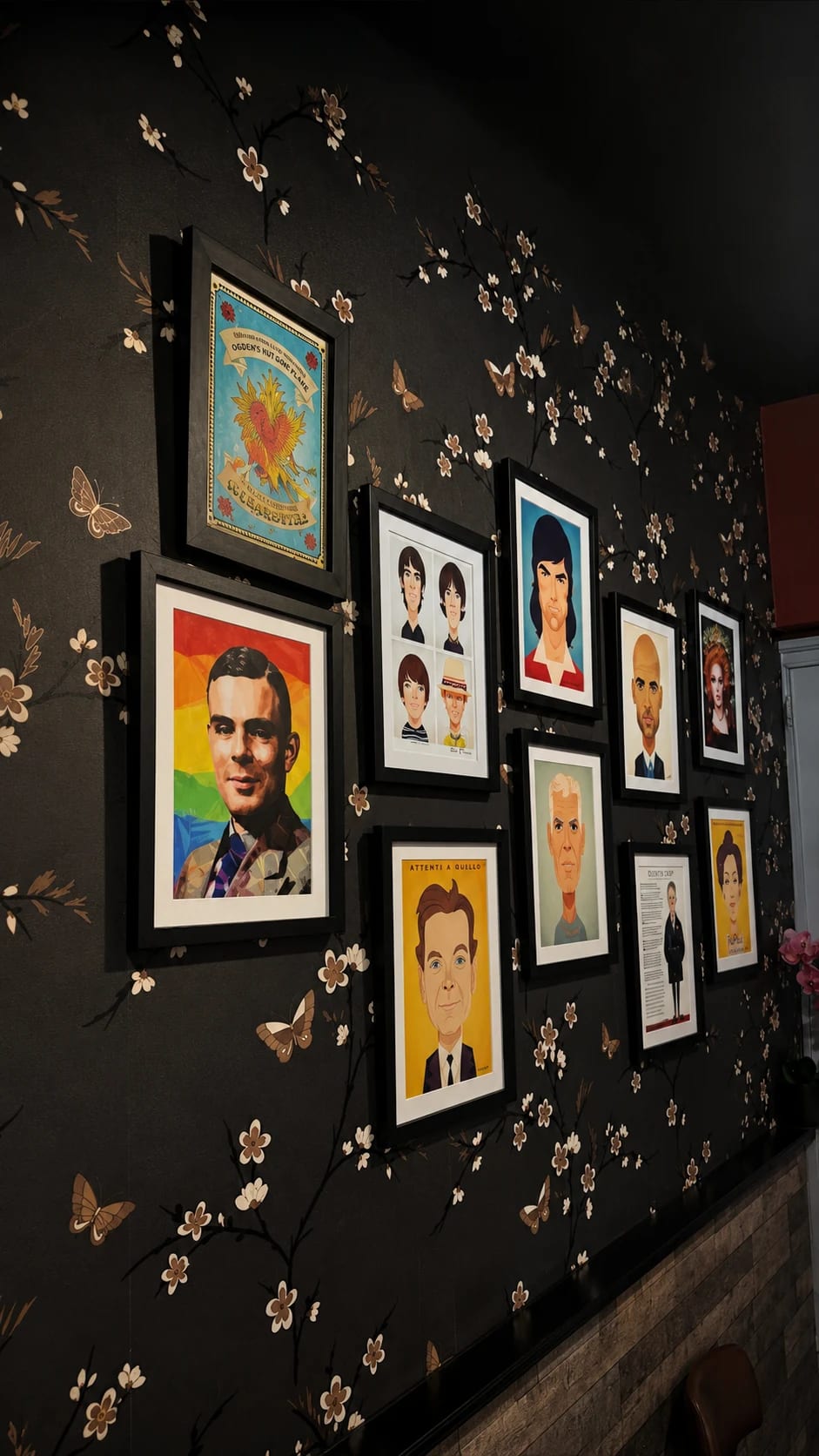 Framed portrait gallery on the wall inside Wok & Flame