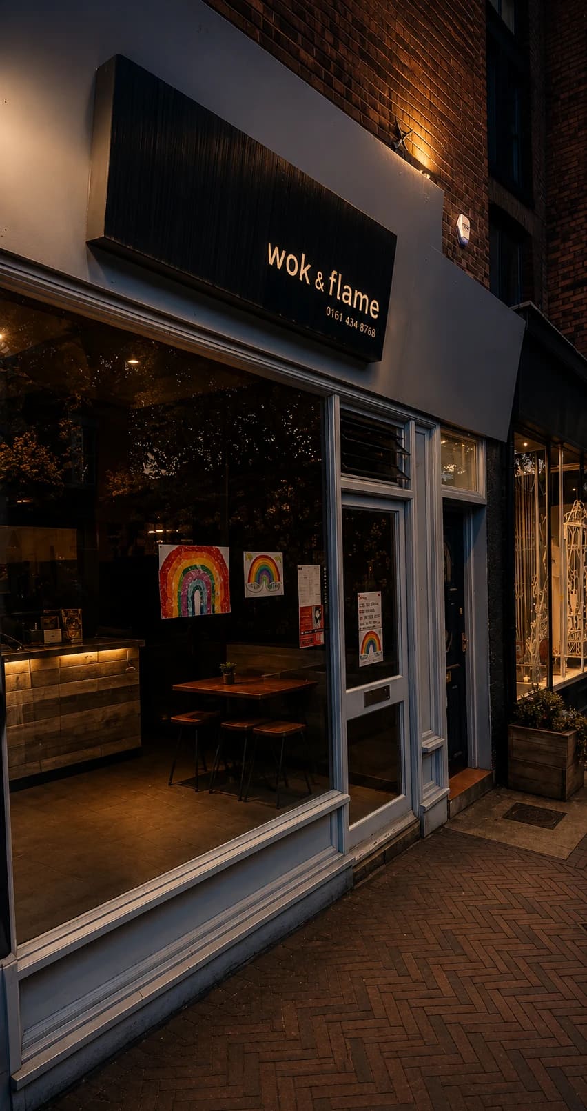 Wok & Flame shopfront on Burton Road, West Didsbury, at dusk